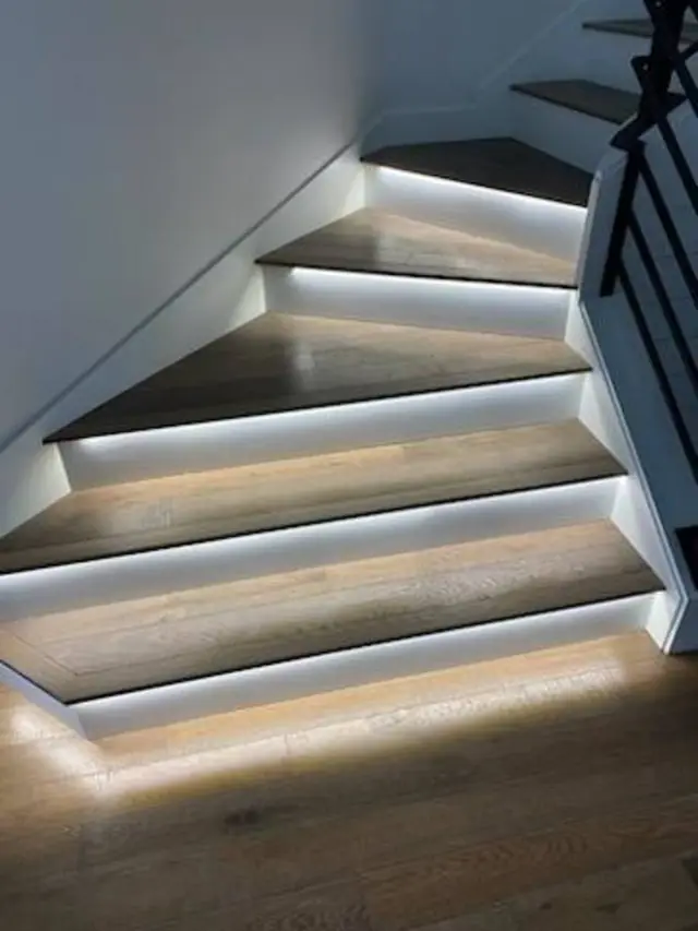 Stair treads lit from below by a low voltage lighting run