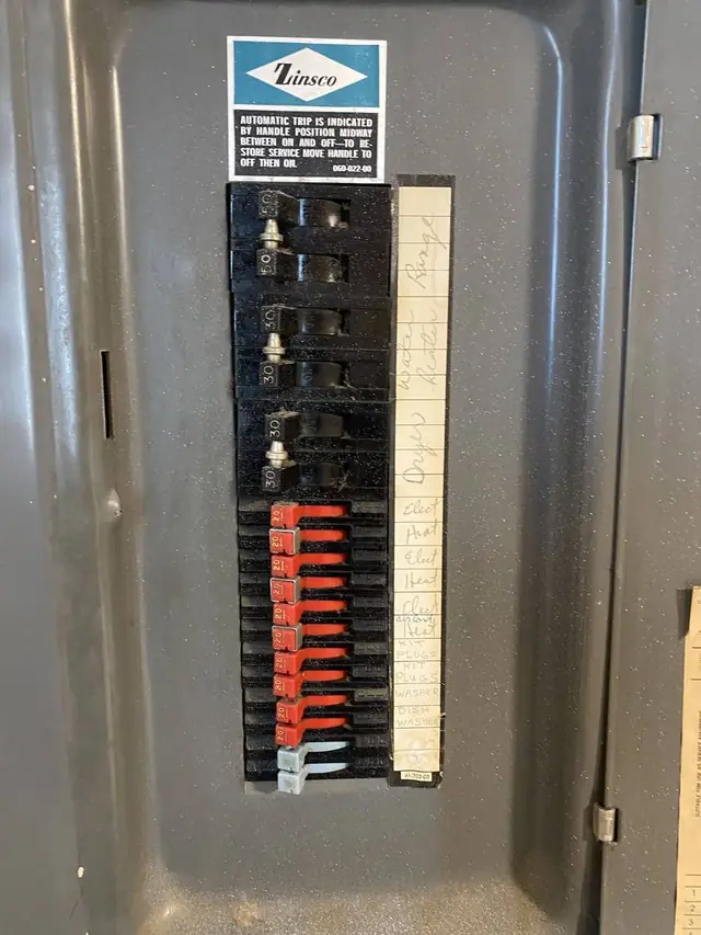 An old Zinsco breaker panel with the Zinsco label on the door, taken before we replaced it